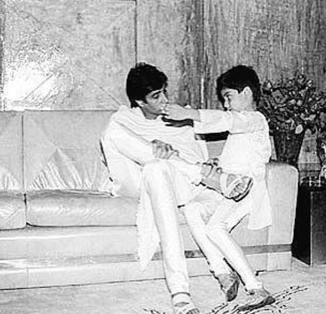 A candid moment captured! A young Abhishek Bachchan keeps company to Amitabh Bachchan.
