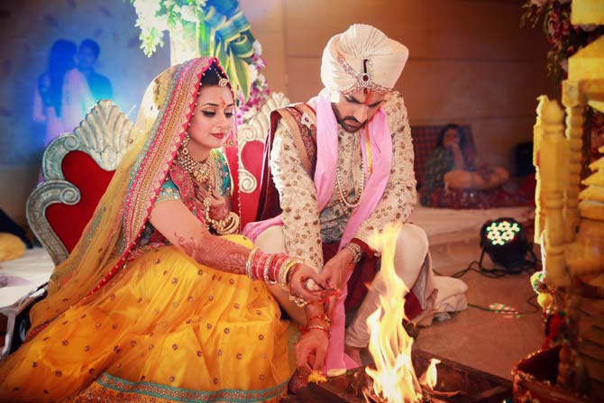 The ceremony started at 9 pm with the entry of the baraat followed by the varmala [garland exchange ceremony].  In picture: Divyanka Tripathi and Vivek Dahiya perform the rituals