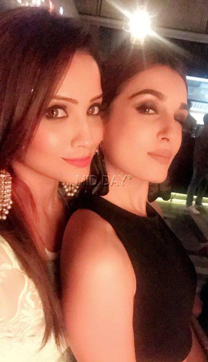 Adaa Khan popular for her roles in 'Naagin' and 'Pardes Mein Hai Mera Dil' poses with a friend at the launch bash for 'Porus'