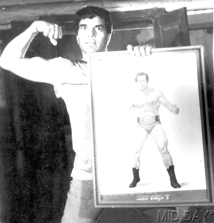 Dharmendra was not at all bothered whether he earned no money, a little money, or a lot! He said, 'My goal was very simple - one flat and one Fiat (car)!' In picture: An old picture of a young Dharmendra holding a photo of Dara Singh