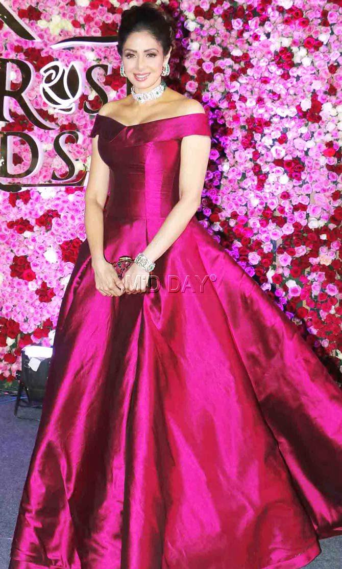 The beautiful Sridevi posing on the red carpet at an awards event. She looked so elegant in this fuchsia gown, don't you agree with us?