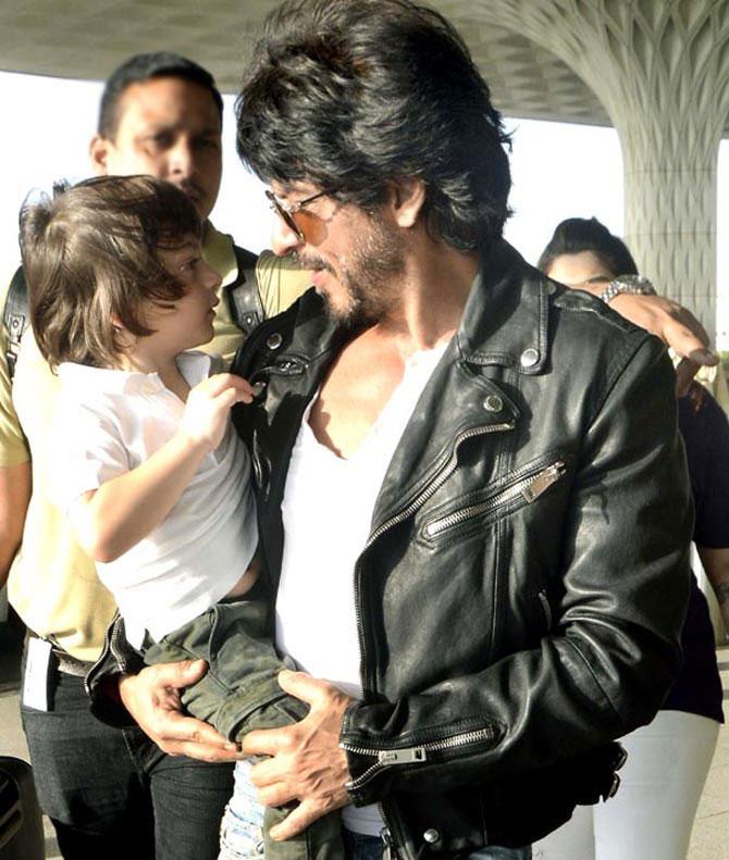 AbRam with father Shah Rukh Khan at Mumbai airport. The little one often gets clicked by the paparazzi, when he is travelling with his family. AbRam with father Shah Rukh Khan at Mumbai airport. The little one often gets clicked by the paparazzi, when he is travelling with his family.