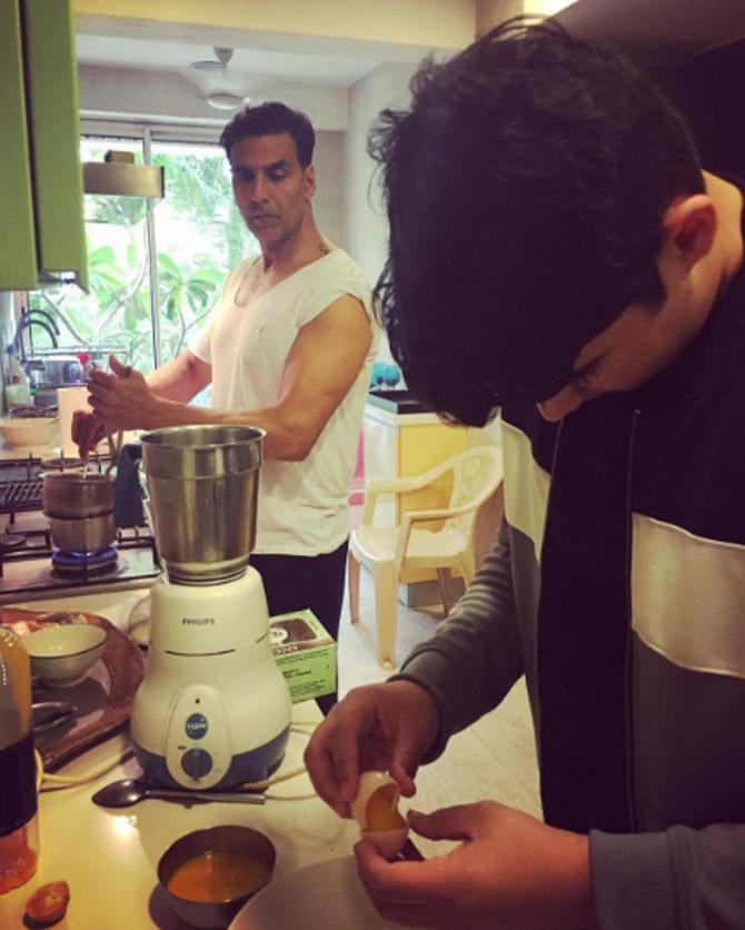 This one's historic! In the picture, Akshay Kumar can be seen preparing food along with his son Aarav in the kitchen. As Aarav breaks the egg, Akshay looks at him intently. Twinkle Khanna captioned the image on social media as, 'Father and son busy making souffle and layered white chocolate mousse for our dinner guests. I have trained my boys well [sic]'