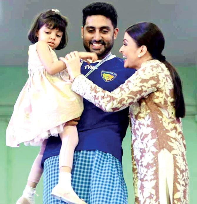 'The global community is the society for our kids today. So I have seen the wonderful influence of travel... Aaradhya is my daughter and I love spending time with her, so I am always travelling with her,' said Aishwarya Rai Bachchan. In picture: Aaradhya Bachchan with parents Aishwarya Rai Bachchan and Abhishek Bachchan at an event.