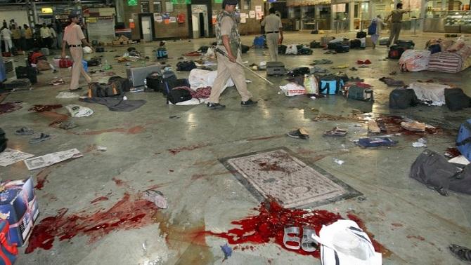 The dastardly attack began on the Chhatrapati Shivaji Maharaj Terminus (CSMT). Being one of the world's busiest train stations, the terrorist managed to rampantly kill hundreds of people. Police officials walking through the station to assist survivors.