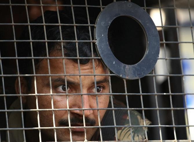 The Mumbai Police and Mumbai ATS also got help from the Indian Central Reserve Police Force (CRPF) soldiers, who joined them for the counter-attack. A police officer is seen here monitoring the situation outside Nariman House.
