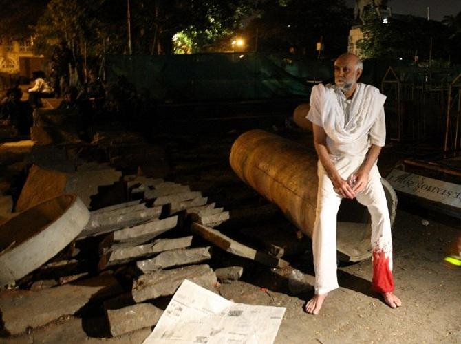 An unidentified survivor, who was wounded, was seen sitting outside the Taj hotel.