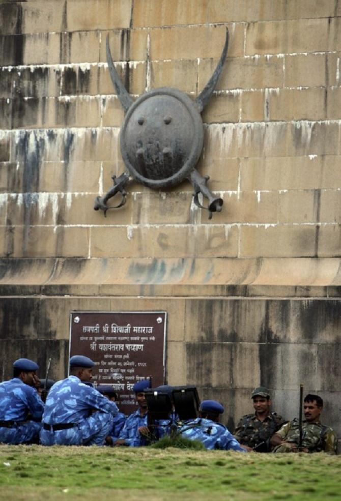 After a night of rigorous operations, members of the Indian National Security Guard rested for a moment at a monument outside the Taj hotel. Many security personnel had also suffered injuries during the attack.