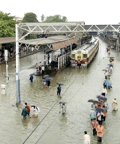 The local train services were majorly hit during the July 26, 2005, floods. According to reports, there were over 1,000 deaths reported during the floods. People took to the railway tracks as they did not want to be stranded and wanted to reach home quickly. In pic: Commuters wade through waterlogged Mahim Station after torrential rains battered Mumbai.