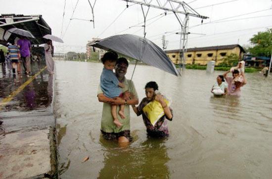 In pic: A family makes their way towards a railway platform during the July 26, 2005 floods in Mumbai.