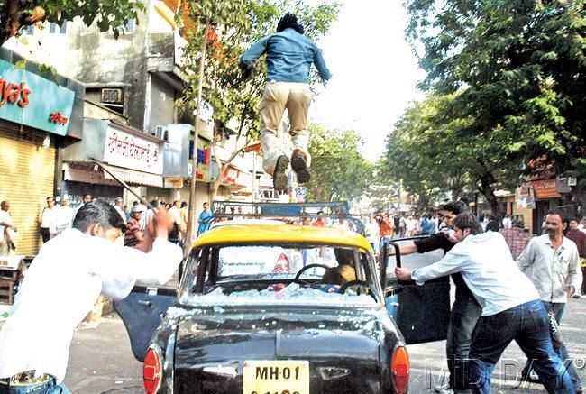 #35 February 3, 2008  VIOLENT FARE: MNS activists smash a cab at Ranade Road, Dadar. MNS activists clashed with Samajwadi Party over a rally to be held at Shivaji Park. pic/DATTA KUMBHAR