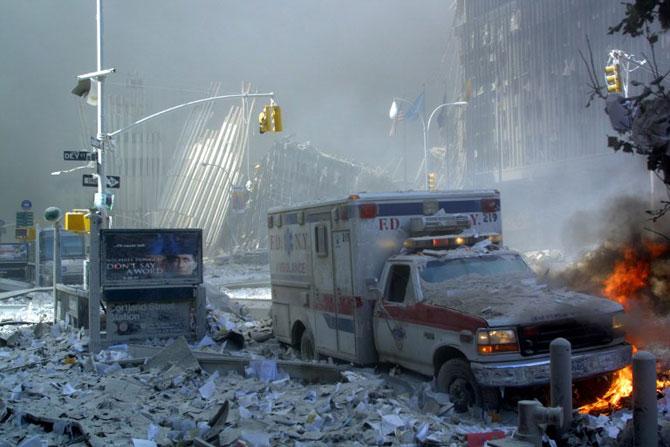 An ambulance, covered with debris, is on fire after the collapse of the first World Trade Center Tower, September 11, 2001 in New York. Two hijacked passenger planes were crashed against the twin towers causing the collapsed of both buildings. Pic/AFP