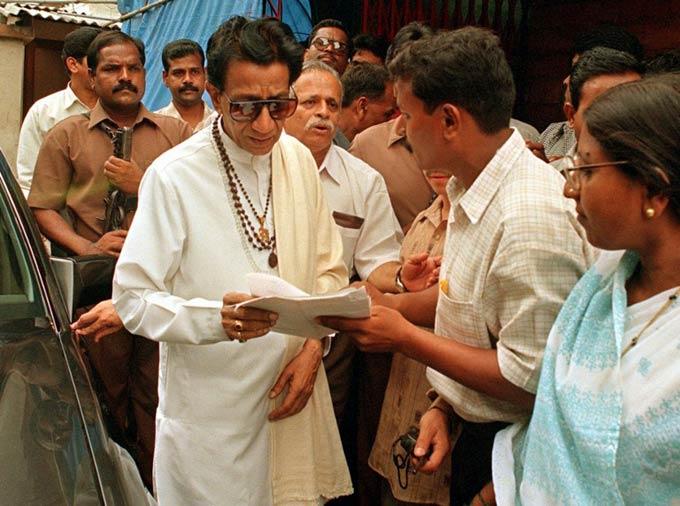 Bal Thackeray speaks with supporters as he leaves party headquaters July 29, 1999, where he met party workers to discuss the national elections to be held in September. The Indian election commission has barred Thackeray from voting or holding public office for six years for inciting Hindu-Muslim violence while on the campaign trail