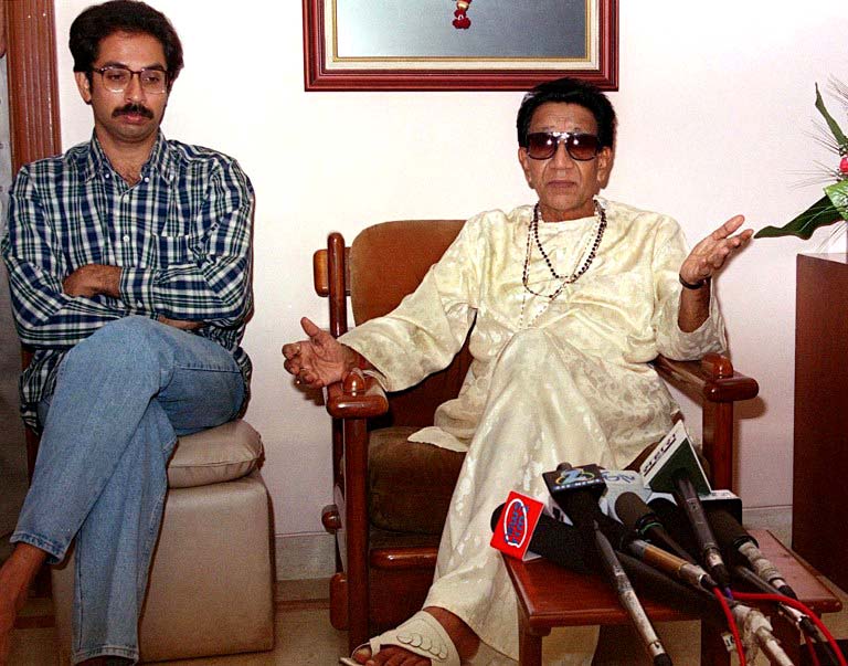 Bal Thackeray looks tense as he speaks to the media, July 21, 2000, at his residence in Mumbai, when he said he had asked his supporters not to resort to any violence despite reports of his possible arrest. But Sena warned that any attempt to arrest the party chief would be challenged in the streets rather than the courts. The state government had sought 27 companies of security forces to maintain law and order in the possibility of Thackeray's arrest. Bal Thackeray's son, Udhav (L) sat beside his father