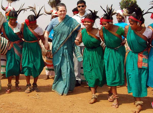 Sonia Gandhi learns the steps of a traditional dance from tribal women during a public meeting in Kothagudem near Hyderabad on February 27, 2009.