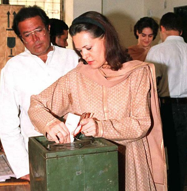 Sonia Gandhi casts her ballot on 27 April 1996 in New Delhi during the first phase of the parliamentary polls. Also seen here is film star Rajesh Khanna, who was a Congress MP and her daughter Priyanka and son Rahul stand in the background.