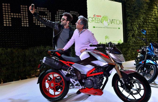 Actor Ranbir Kapoor clicks a selfie with Pawan Munjal, Chairman, MD & CEO, Hero MotoCorp at the launch of Hero's new motorcycle at Auto Expo 2016 in Greater Noida on Wednesday. Pic/PTI 