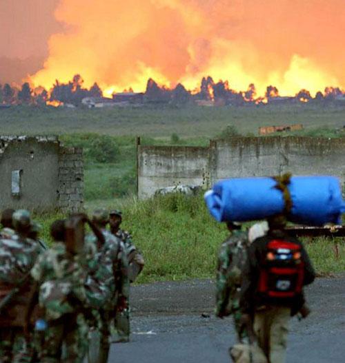 Rwanda soldiers escape from the erupting volcano of Mount Nyiragongo, Goma in Democratic Republic of Congo on 18 January 2002. Tens of thousands of residents of Goma fled their homes, around 147 people died and vast areas of the town were set ablaze by the lava flows from the volcano.