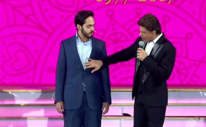 When Shah Rukh Khan asked Anant Ambani about all the weight he had shed, Anant Ambani humourously replied saying that he would pose no competition to Bollywood. Pic/YouTube In picture: Anant Ambani and Shah Rukh Khan