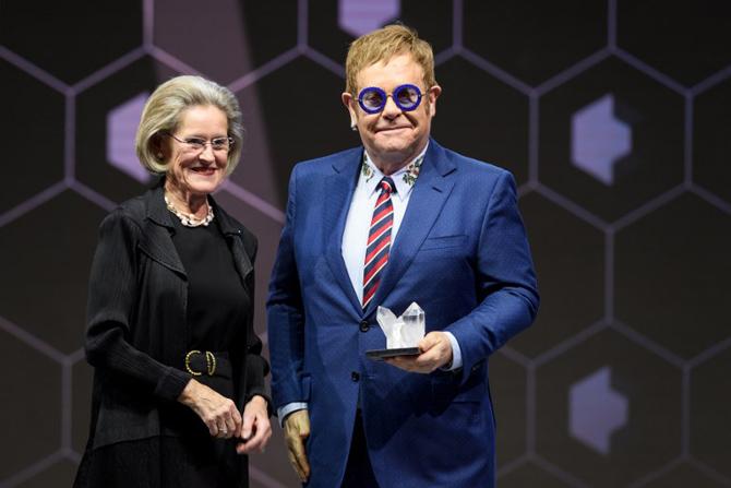 British singer Sir Elton John receives a Crystal Award from the hands of Schwab Foundation for Social Entrepreneurship Chairperson and Co-Founder Hilde Schwab during a ceremony ahead of the World Economic Forum (WEF) 2018 annual meeting. Pic/AFP British singer Sir Elton John receives a Crystal Award from the hands of Schwab Foundation for Social Entrepreneurship Chairperson and Co-Founder Hilde Schwab during a ceremony ahead of the World Economic Forum (WEF) 2018 annual meeting. Pic/AFP
