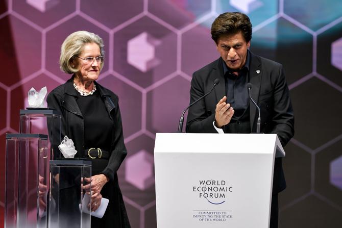 Shah Rukh Khan thanks the assembly as he stands next to Schwab Foundation for Social Entrepreneurship Chairperson and Co-Founder Hilde Schwab after receiving a Crystal Award during a ceremony. Pic/AFP Shah Rukh Khan thanks the assembly as he stands next to Schwab Foundation for Social Entrepreneurship Chairperson and Co-Founder Hilde Schwab after receiving a Crystal Award during a ceremony. Pic/AFP
