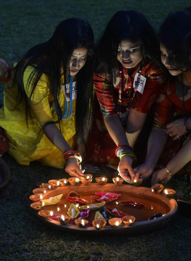 People across the world celebrated regional new years like Baisakhi and Poila Baishak with fervour. (In picture: Bengali women places earthen lamps to celebrate the Bengali New Year, also known as Poila Baishak in Siliguri, West Bengal). All pics/AFP