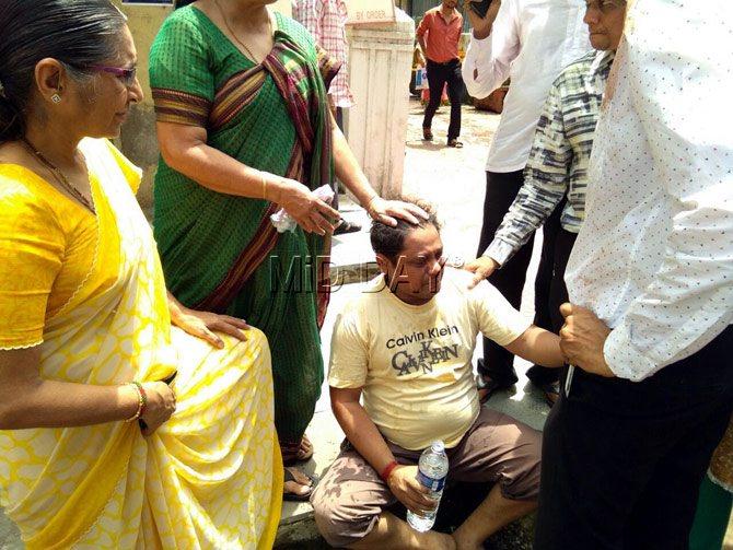 A bereaved family member crumbles under the trauma of what he has just experienced