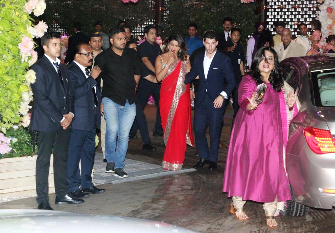 Priyanka wore a bright red sari from the studios of Abu Jani and Sandeep Khosla and paired it with a golden blouse, bracelet and a pair of earrings. While Nick complimented her in a blue suit