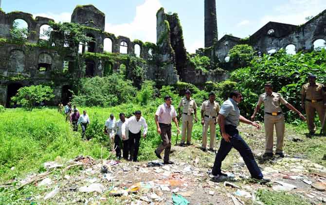 Himanshu Roy oversaw the investigation into the August 2013 gang-rape of a woman photo-journalist inside the desolate Shakti Mills Compound in central Mumbai which culminated in death sentence for three of the accused. In picture: Joint Commissioner of Police Himanshu Roy (3R) along with other policemen exit the Shakti Mills compound, the scene of a brutal gang rape of a female photojournalist, in Mumbai on August 28, 2013. PIC/AFP