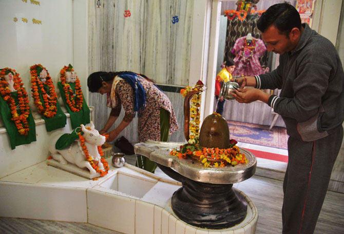 Devotees pour milk over the Shivling, on the eve of Mahashivratri at the Shivala Temple in Amritsar on March 6. Pic/AFP