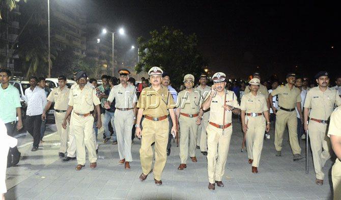 Mumbai Police Commissioner Ahmad Javed with an entourage of police officers during crowd control measures at Marine Drive