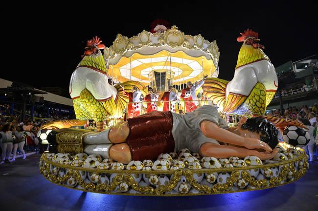 Performers wave at the audience from a carnival float during carnival parade at Sambadrome in Rio de Janeiro