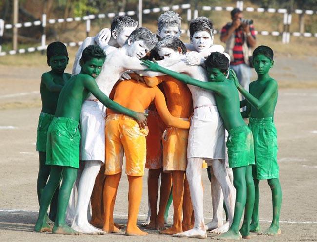 Indian school students painted in the colours of the national flag perform a dance during Republic Day celebrations in Secunderabad, the twin city of Hyderabad, on January 26, 2014