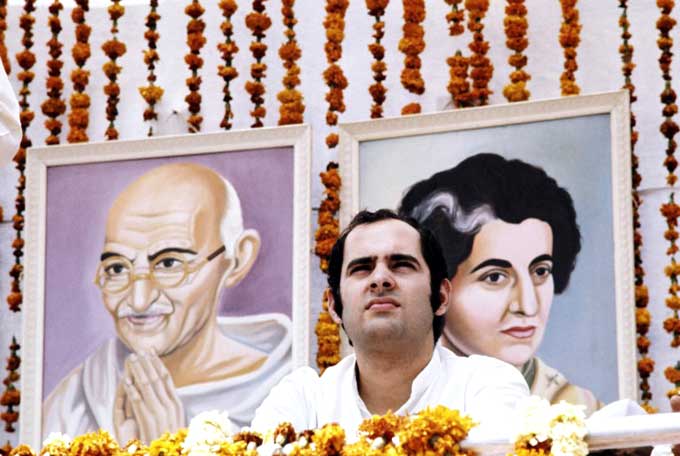 Sanjay Gandhi escaped an assassination attempt in March 1977 when unknown assailants fired at his car during an election campaign near New Delhi. In pic: A picture of Sanjay taken during a meeting in Avril in 1976 in front of the portrait of Mahatma Gandhi and of his mother Indira Gandhi. Pic/AFP