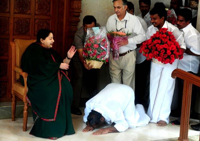 Jayalalithaa was re-elected as Chief Minister on May 19, 2016 and took the oath as Chief Minister for the sixth time on May 23, 2016. In picture: A party cadre prostrates himself at the feet of All India Anna Dravida Munnetra Kazhagam(AIADMK) leader Jayalalithaa as she gestures at her residence in Chennai on May 19, 2016