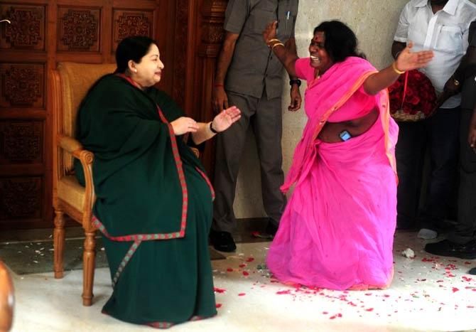 Jayalalithaa, who was the second Chief Minister of Tamil Nadu after MGR's wife Janaki Ramachandran, served as Chief Minister from 1991 to 1996, in 2001, from 2002 to 2006 and from 2011 to 2014. She became the first incumbent chief minister in India to be disqualified from holding office due to conviction in a disproportionate assets case on September 27, 2014 In picture: A party cadre celebrates victory with All India Anna Dravida Munnetra Kazhagam (AIADMK) leader Jayalalithaa R as she gestures at her residence in Chennai on May 19, 2016