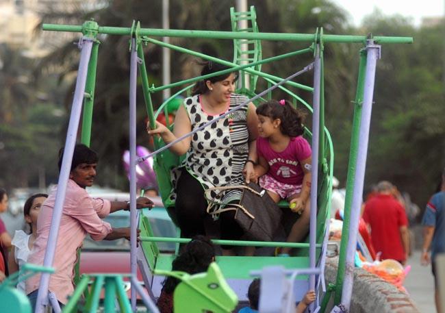 A mother and her daughter go for a spin on a Ferris wheel. 
Pic/Sameer Markande