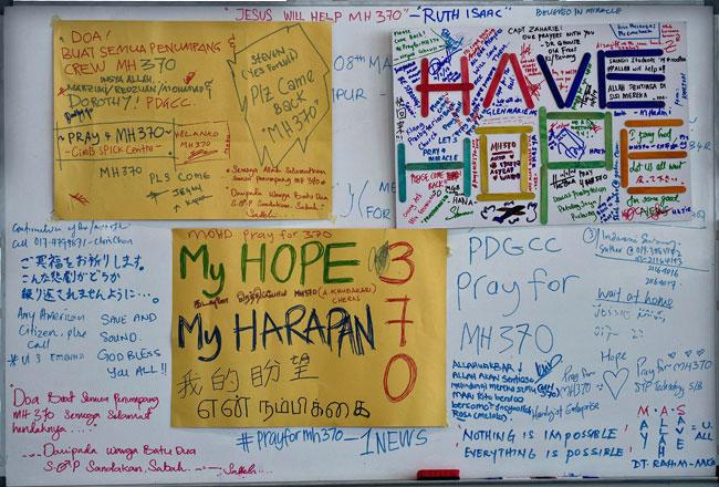 A board displaying messages for the passengers from the missing Malaysia Airlines flight MH370 is seen at Kuala Lumpur International Airport in Sepang on March 11, 2014.  Malaysia has expanded its search area for the missing Malaysia Airlines flight MH370 jet after three days of scouring the sea failed to bring forth any confirmed sightings of wreckage, an official said