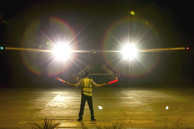 This picture taken on March 10, 2014 shows ground staff signaling as a Vietnamese Air Force seaplane lands upon return from a search and rescue mission for the missing Malaysia Airlines (MAS) flight MH370 off Vietnam's southern coastline, at a military base on the southern island of Phu Quoc.  Dozens of ships and aircraft from multiple nations scoured an expanded swathe of Southeast Asia on March 11 for any sign of a Malaysian jet that vanished with 239 people on board, as frustration mounted over the baffling disappearance
