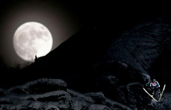 Norway's Anders Bardal jumps during the official training session of the FIS Ski Flying World Cup in Vikersund, Norway on January 25, 2013, while a full moon rises over the mountain