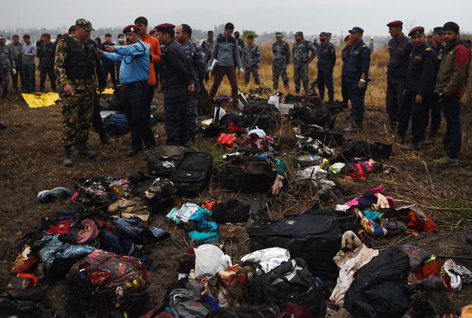 The belongings of passengers travelling on an airplane that crashed lie at the crash site near the international airport in Kathmandu. Pic/AFP