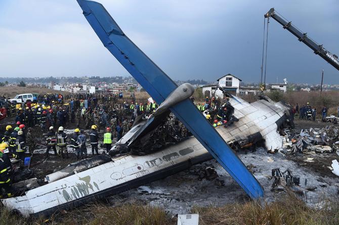 Officials said that the passenger plane had 71 people on board the US-Bangla Airlines plane from Dhaka when it crashed just east of the runway of Nepal's Tribhuvan international airport and skidded into a nearby football field. The passenger plane from Bangladesh crashed and burst into flames as it landed in Kathmandu, killing dozens of people, officials said. Pic/AFP