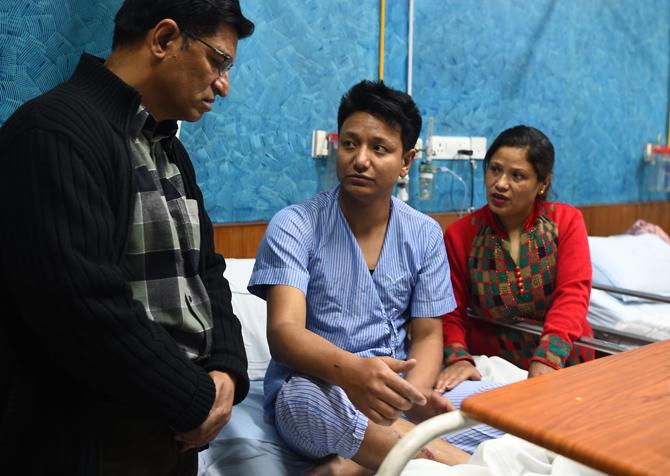 Plane crash survivor Sanam Shakya, who escaped from the craft's window, met his parents at the Norvic Hospital in Kathmandu. Pic/AFP