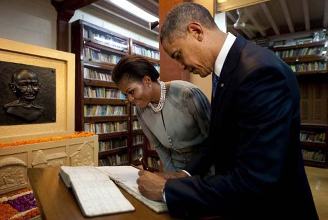 US President Barack Obama (R) and First Lady Michelle Obama (L) write in the visitors book during their tour through the Mani Bhavan Gandhi Museum in Mumbai on November 2010. Pic/AFP