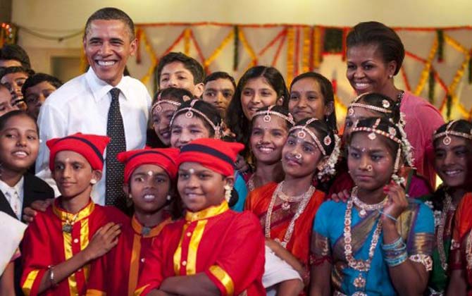 US President Barack Obama (L) and First Lady Michelle Obama (R) pose with performers during a cultural event at The Holy Name High School in Mumbai on November 2010. Pic/AFP