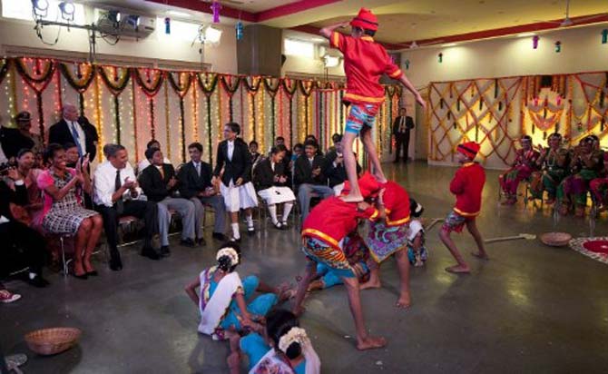 The Obamas watch a cultural event at The Holy Name High School in Mumbai. Pic/AFP