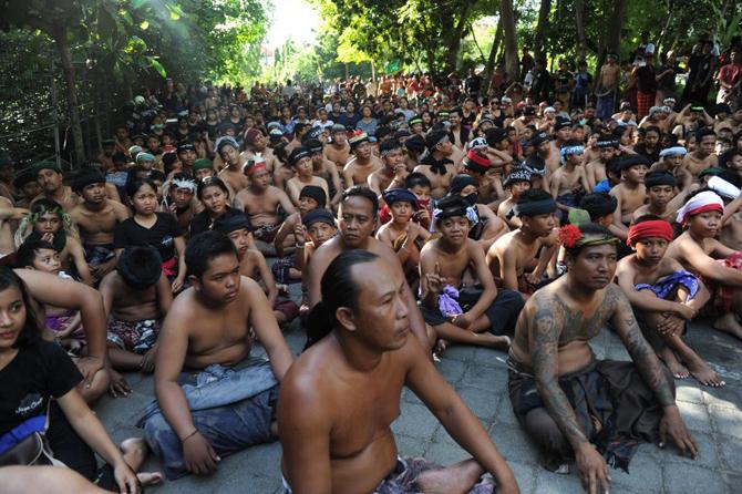 Balinese people prepare to go to the mangrove to put mud on their body during the traditional mud baths in Kedonganan village, near Denpasar, Bali