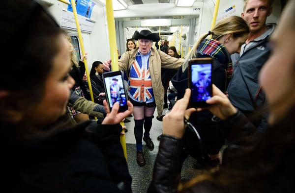 Participants in the annual International 'No Pants Subway Ride' arrive at a train station in London, on January 10, 2016