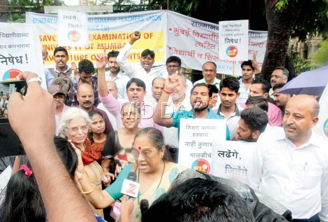 Teachers staged a protest against Mumbai University's demand that they finish assessing all papers by July 20 despite glitches in the new online system