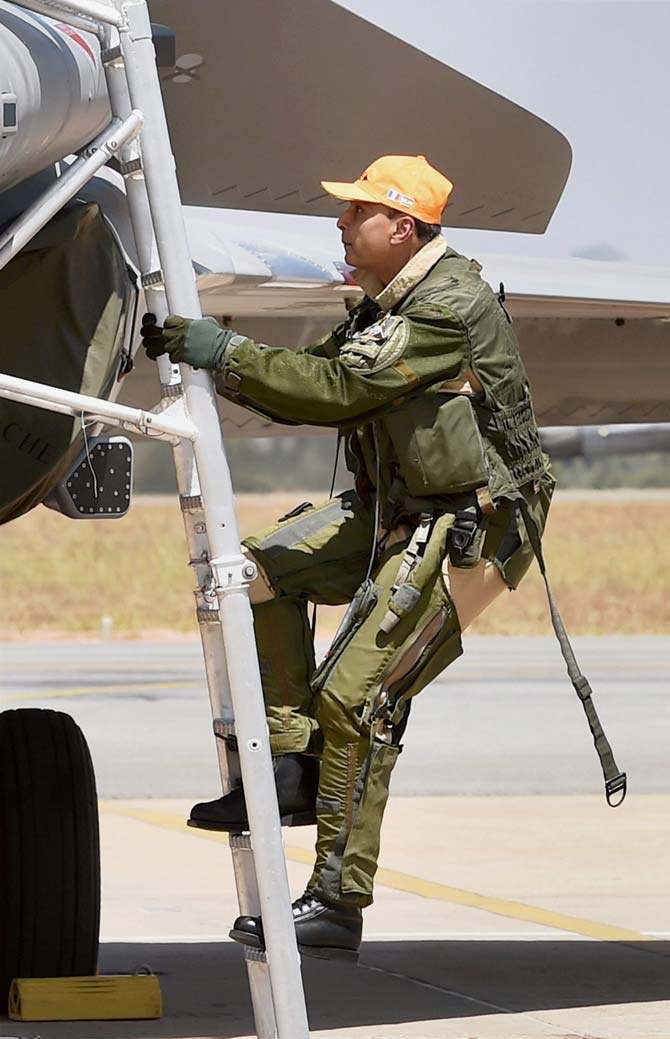 Reliance Group Chairman Anil Ambani climbs in the cockpit of Rafale aircraft before a sortie during the 2nd day of the 11th biennial edition of Aero India 2017 at Yelahanka Air base in Bengaluru on Wednesday. Pic/PTI